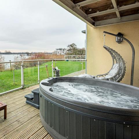 Sink into the hot tub overlooking the lake