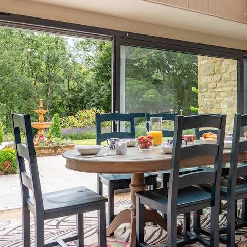 Throw open the glass doors and enjoy dinner with a view of the manicured garden