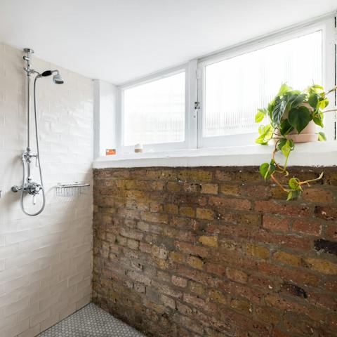 Start your morning with a refreshing soak beneath the brick-framed shower