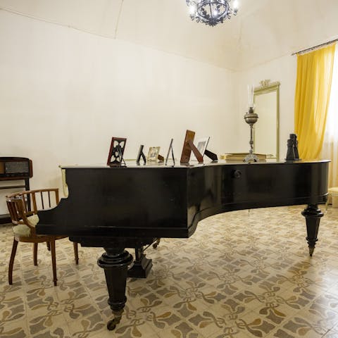 Tickle the ivories of the grand piano in the music room