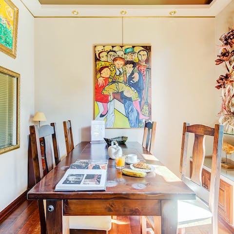 Gather around the art-framed dining table for breakfast