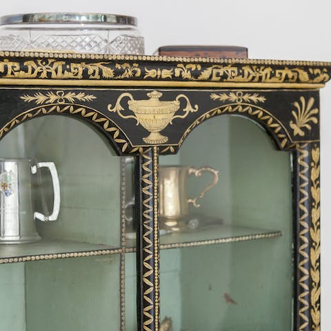 Admire the period features and antiques, like the Chinese cabinet