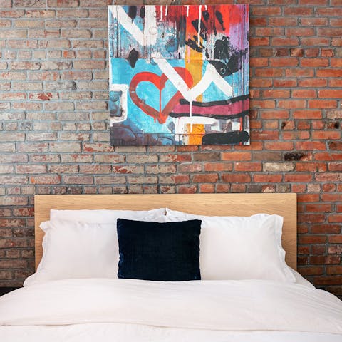 Fall to sleep each night underneath the NY-inspired backdrop of exposed brickwork and street art