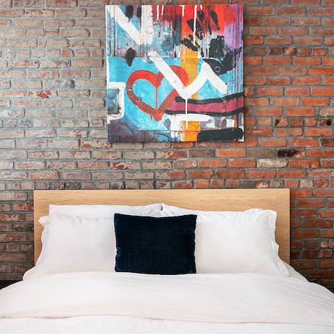 Fall to sleep each night underneath the NY-inspired backdrop of exposed brickwork and street art