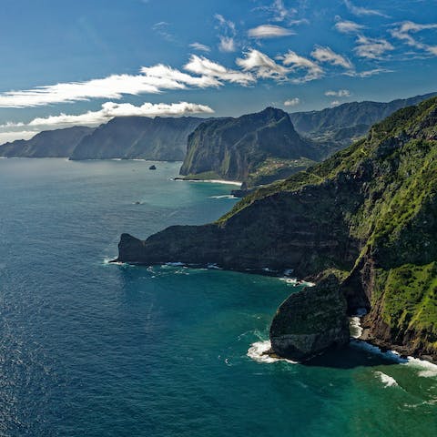 Discover Madeira's soaring mountains, plunging cliffs and bustling city life from the heart of Funchal