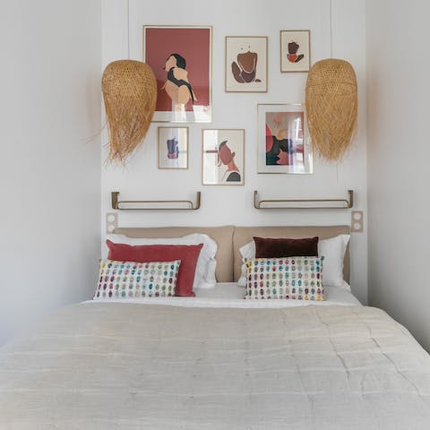 Admire the trendy prints and beach-style lighting from your comfy bed