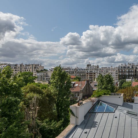 Enjoy wide sweeping views of the 16th arrondissement's rooftops from the large windows 