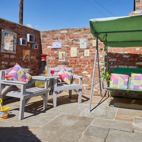 Relax in the sun-trap courtyard on warm summer days