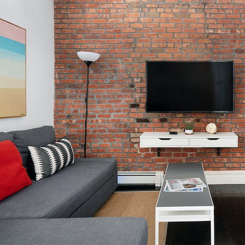 Relax in an industrial-chic living space with exposed brick walls