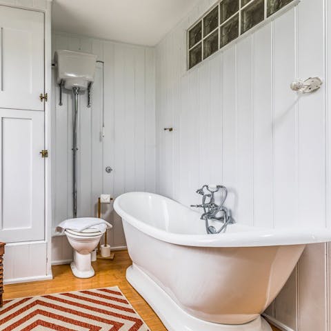 Luxuriate in the home's freestanding bathtub complete with views of the South Downs