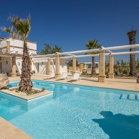 Enjoy a rejuvenating dip in the sparkling outdoor pool, or relax on a poolside lounger