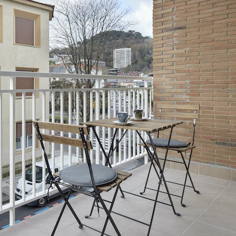 Savour your morning coffee on the balcony, watching the street below spring into action