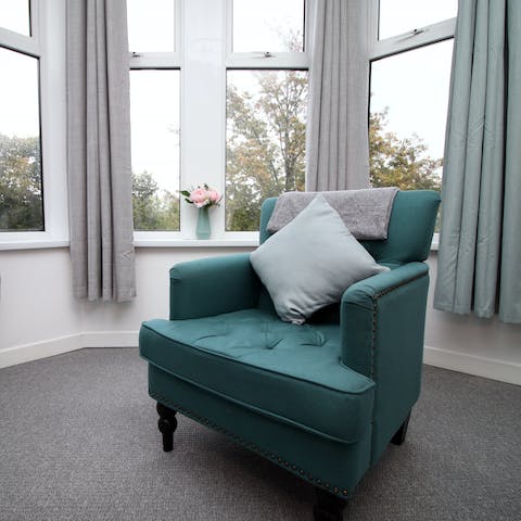 Sit and read on the comfy armchair in the bay window