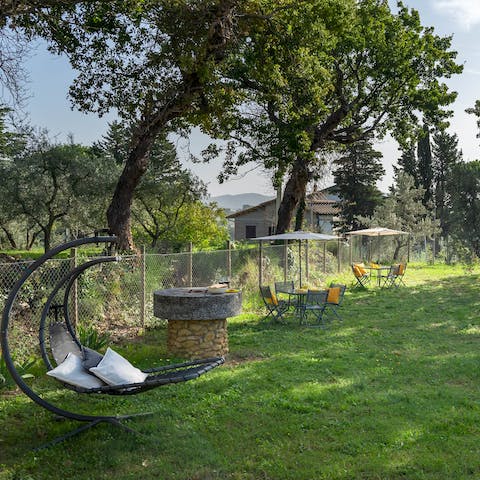 Recline on the hanging chair beneath olive trees and get lost in a good book