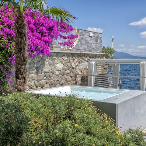 Sink into the hot tub and admire the sea views
