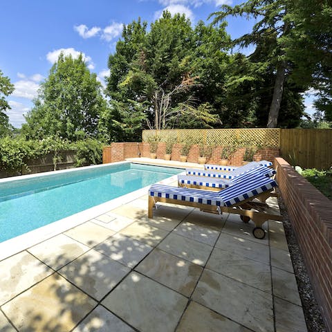 Dip your toes into your private outdoor pool in the hazy summer months