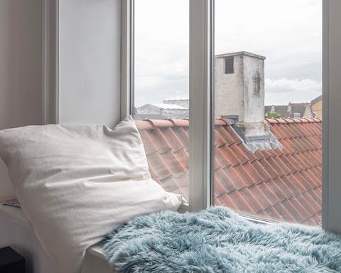 This window seat with views of Copenhagen roofs