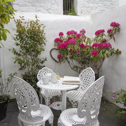 Spend warmer days relaxing with a good book on the pretty patio