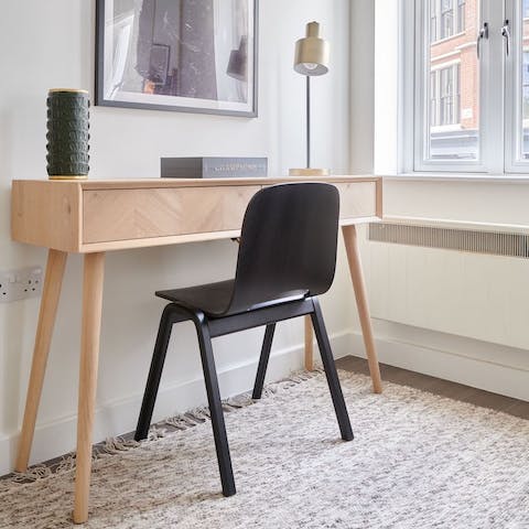 A wooden Scandi desk and chair