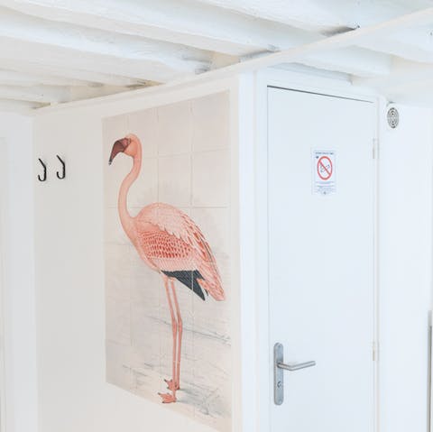A pink flamingo on the wall