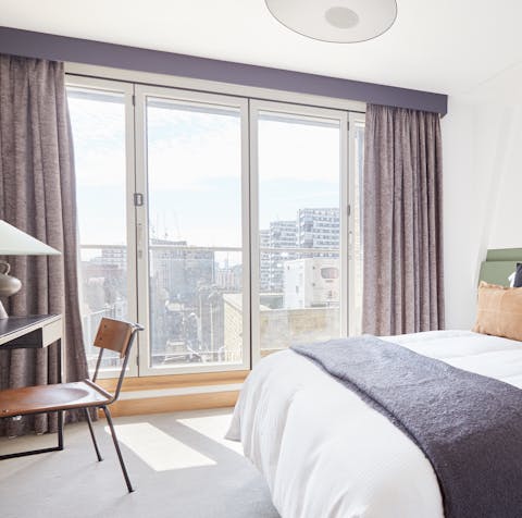 Wake up to floor-to-ceiling city views in the bedroom