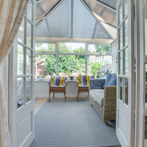 Relax with a good book and a mug of tea in the sunny conservatory