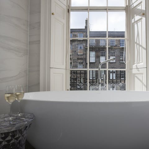 Unwind with a soak in the sumptuous bathtub and admire the views from the traditional sash windows