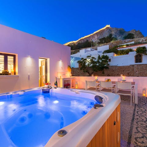 Watch the lights of ancient Lindos glow and the stars above sparkle from your private hot tub