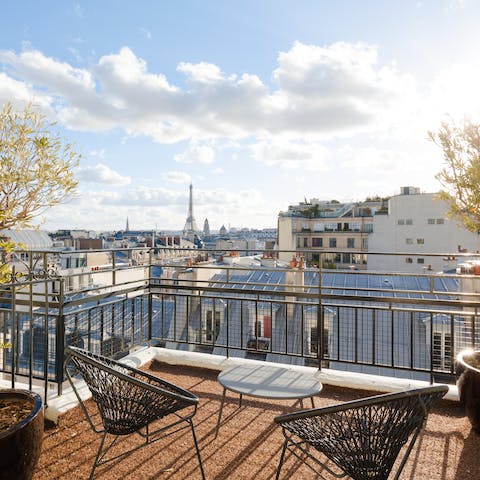 Take in stunning views of the Eiffel Tower from the private terrace, a glass of French wine in hand