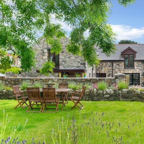 Dine together on the grassy terrace beneath the trees