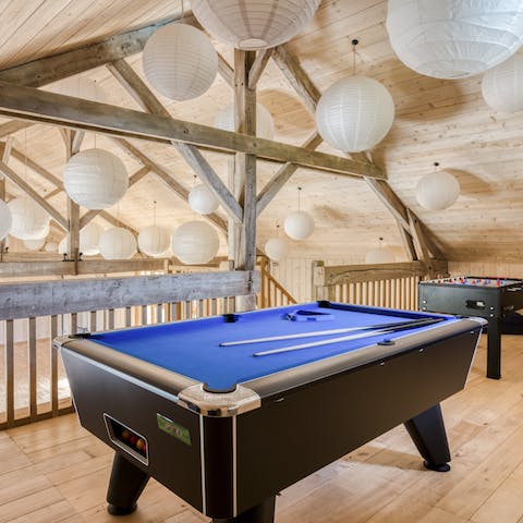 Play a game of pool in the air conditioned barn