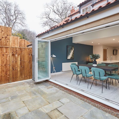 Slide open the bifold doors and turn the dining table into an alfresco situation