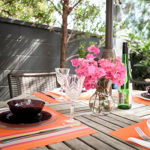 Sit out at the patio dining table, a perfect spot for dinner
