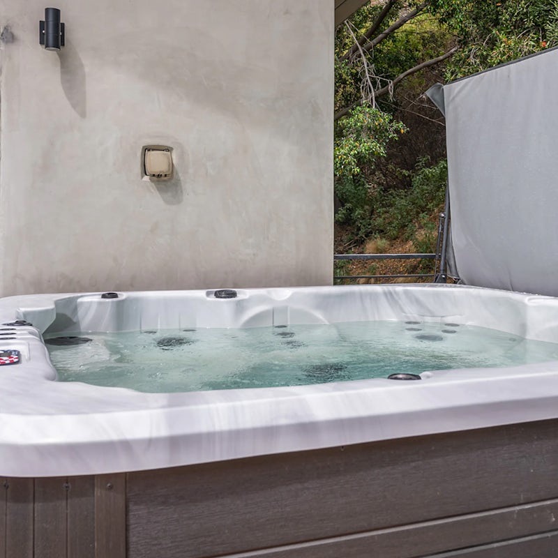 Relax in the hot tub while looking out at the twinkling cityscape