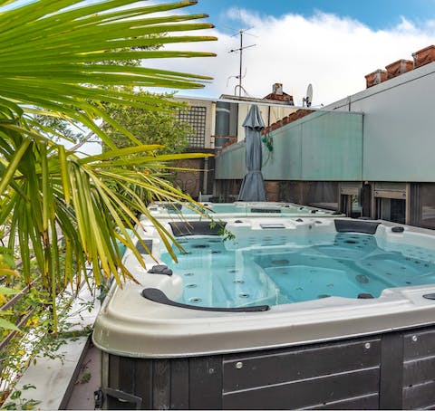 Enjoy a relaxing soak with a glass of something bubbly in the hot tub 