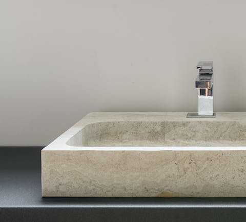 A design-forward sandstone sink