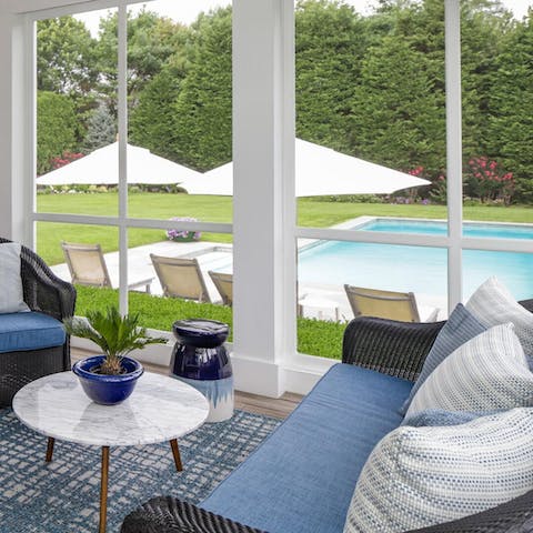 Enjoy additional relaxation from the sunroom overlooking the pool