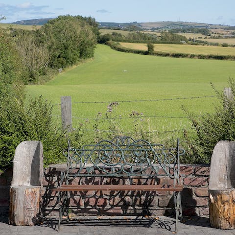 Sit with a glass of wine and drink in the rolling countryside views