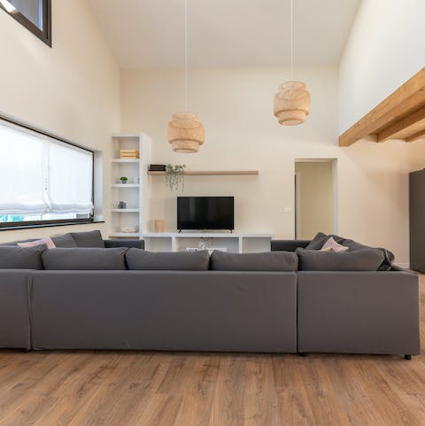 Enjoy a moment of down time as you snuggle up in the open–plan living area in front of the TV