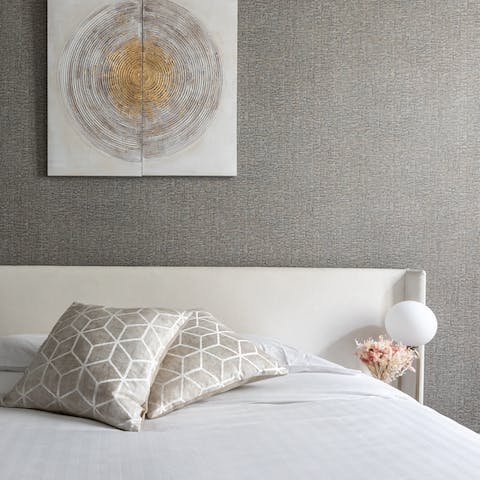 Wake up in style in the lofty, contemporary bedroom