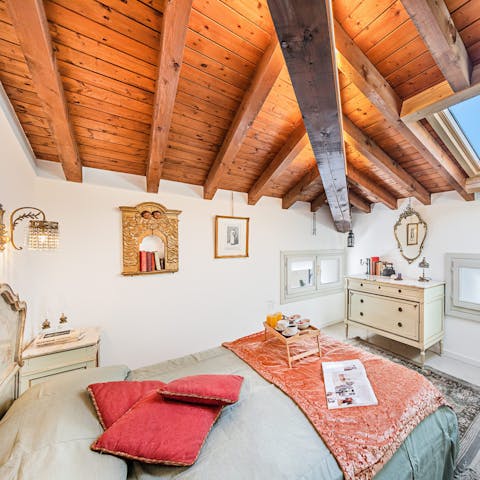 Drift off to sleep underneath timber beams and wooden ceilings in the characterful bedroom