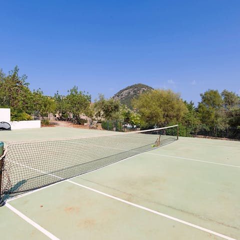 Keep on top of your fitness with a round of tennis on the private court