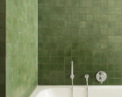 Treat yourself to a soak in the green tiled tub after a day of exploring the city on foot
