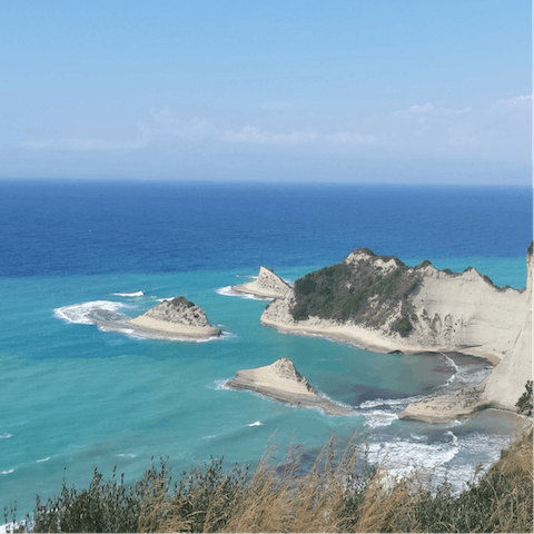 Explore the coves and bays of Corfu's coast by hiring a boat