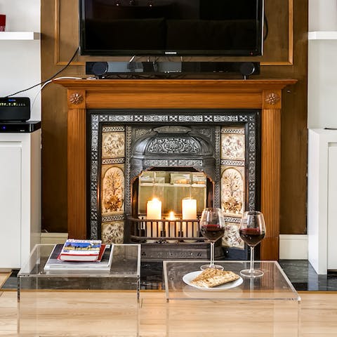 Cosy up around the stunning ornate fireplace with a glass of wine