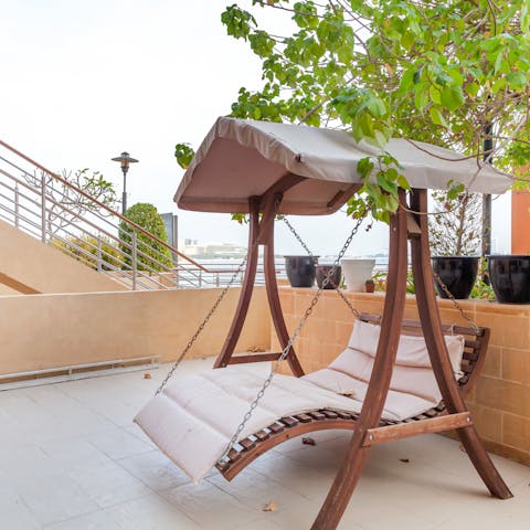 Catch a glimpse of the sea from the swing chair of your private terrace