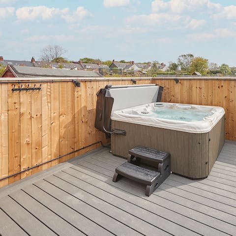 Enjoy the soothing bubbles of your hot tub with a glass of wine to unwind