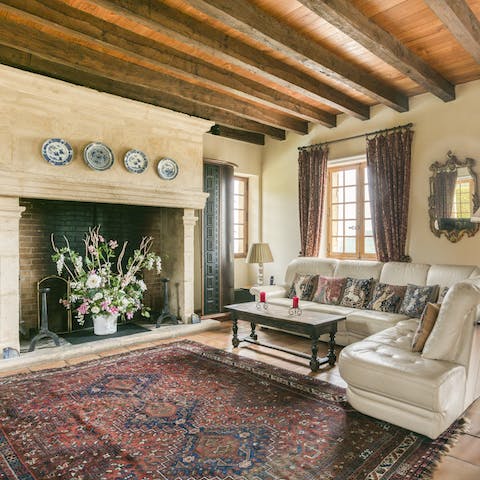 Get cosy on the sofa with a novel below the beams of the grand sitting room