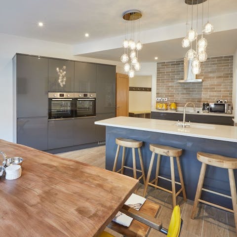 Knock up a lazy brunch in the modern kitchen, which has a double oven and a sociable breakfast bar