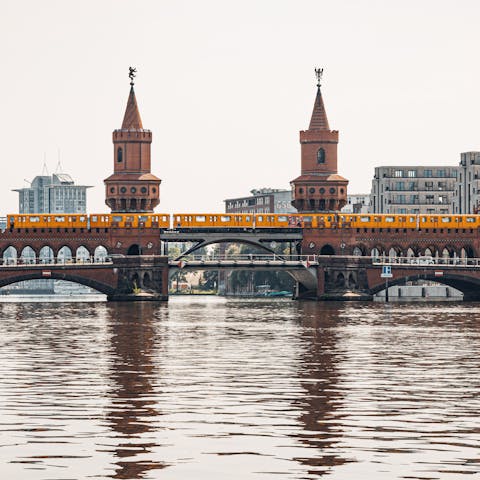 Stroll alongside the river towards the Oberbaumbrücke Bridge